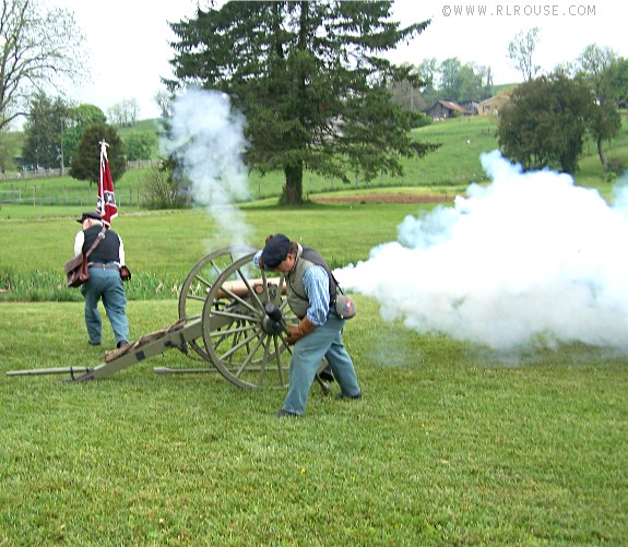 A 12 Pound Mountain Howitzer firing a round.