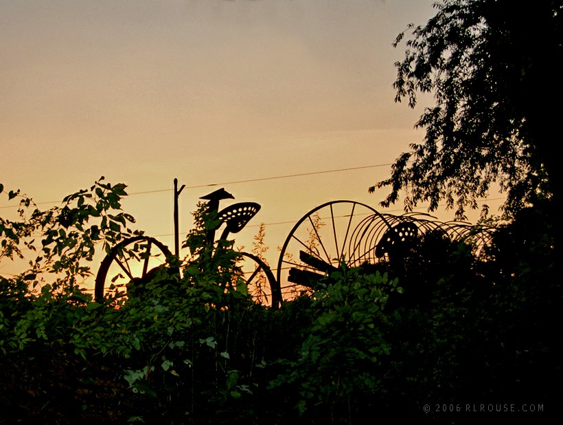 Antique farm implements at dusk.