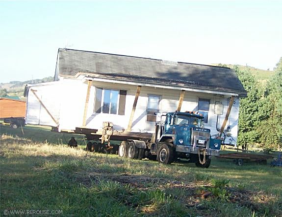 House movers in the process of moving a house.