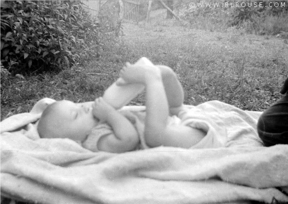 Roger using his feet to hold his bottle.